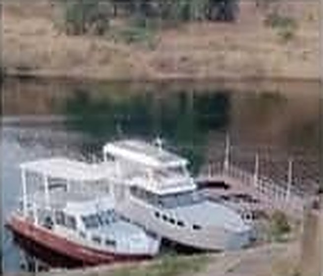 Two cruise boats moored at the lakehouse dock