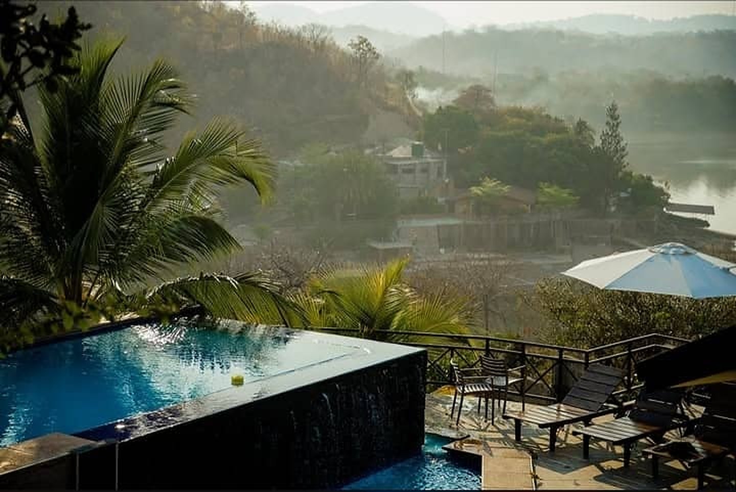 Infinity pool at Miselo's Lakehouse looking out over the misty lake and hills