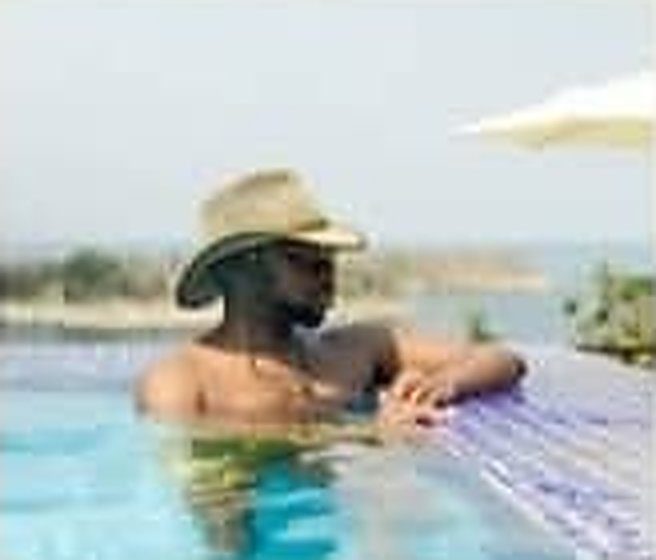 A guest relaxing at the pool edge